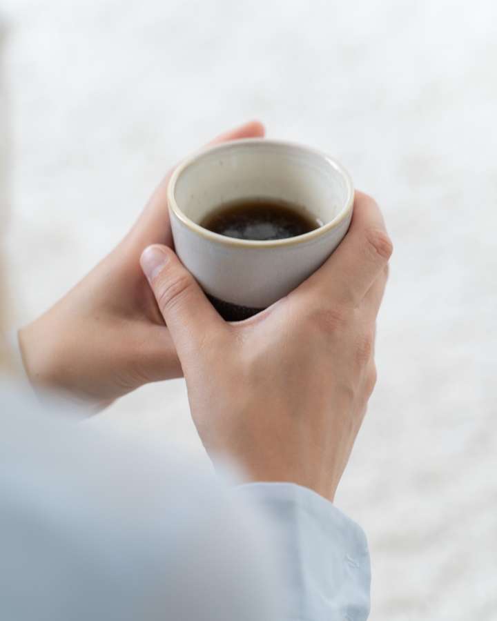 Hands holding a cup of tea
