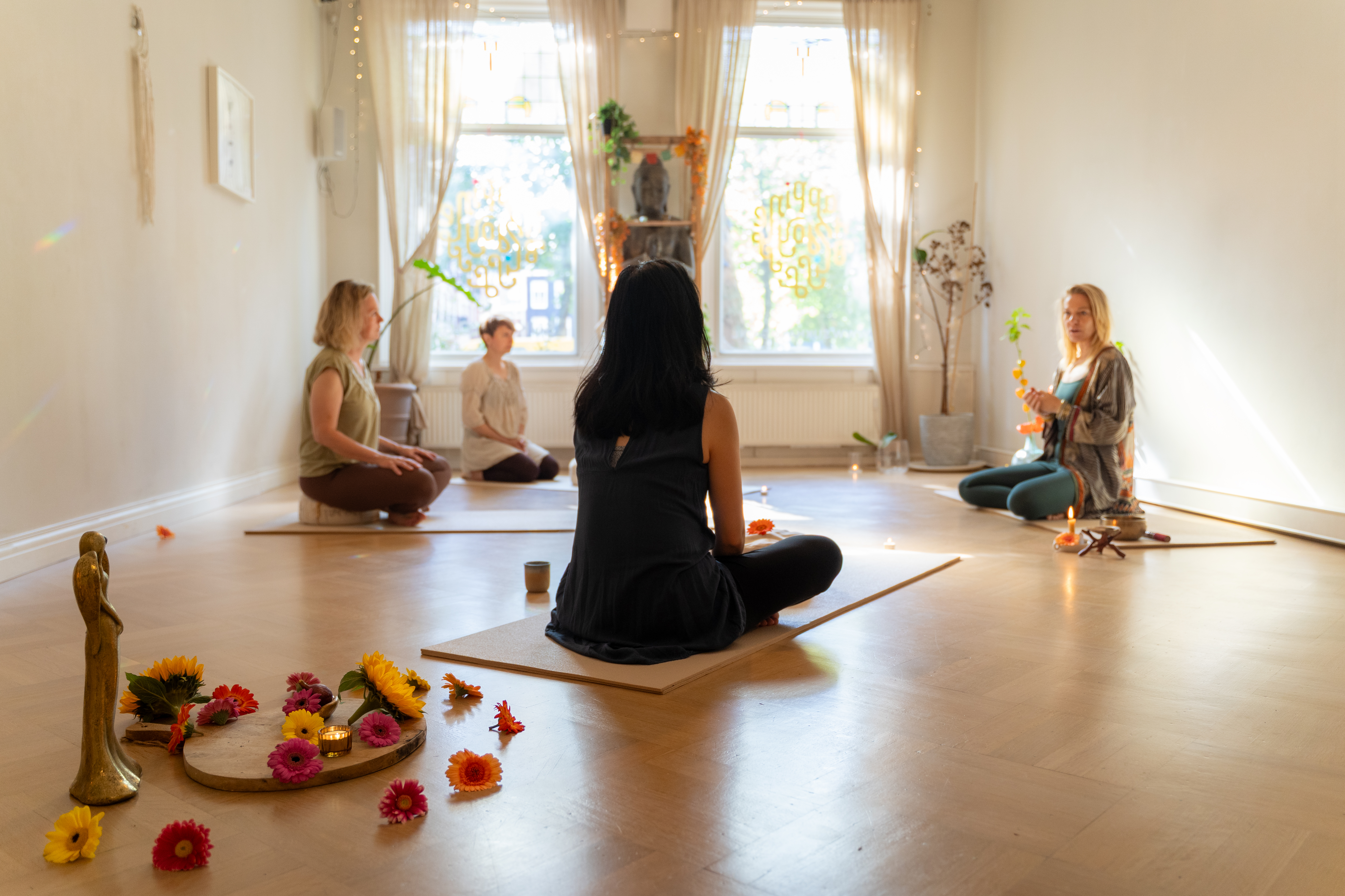 small-group-of-women-sitting-on-yoga-mat