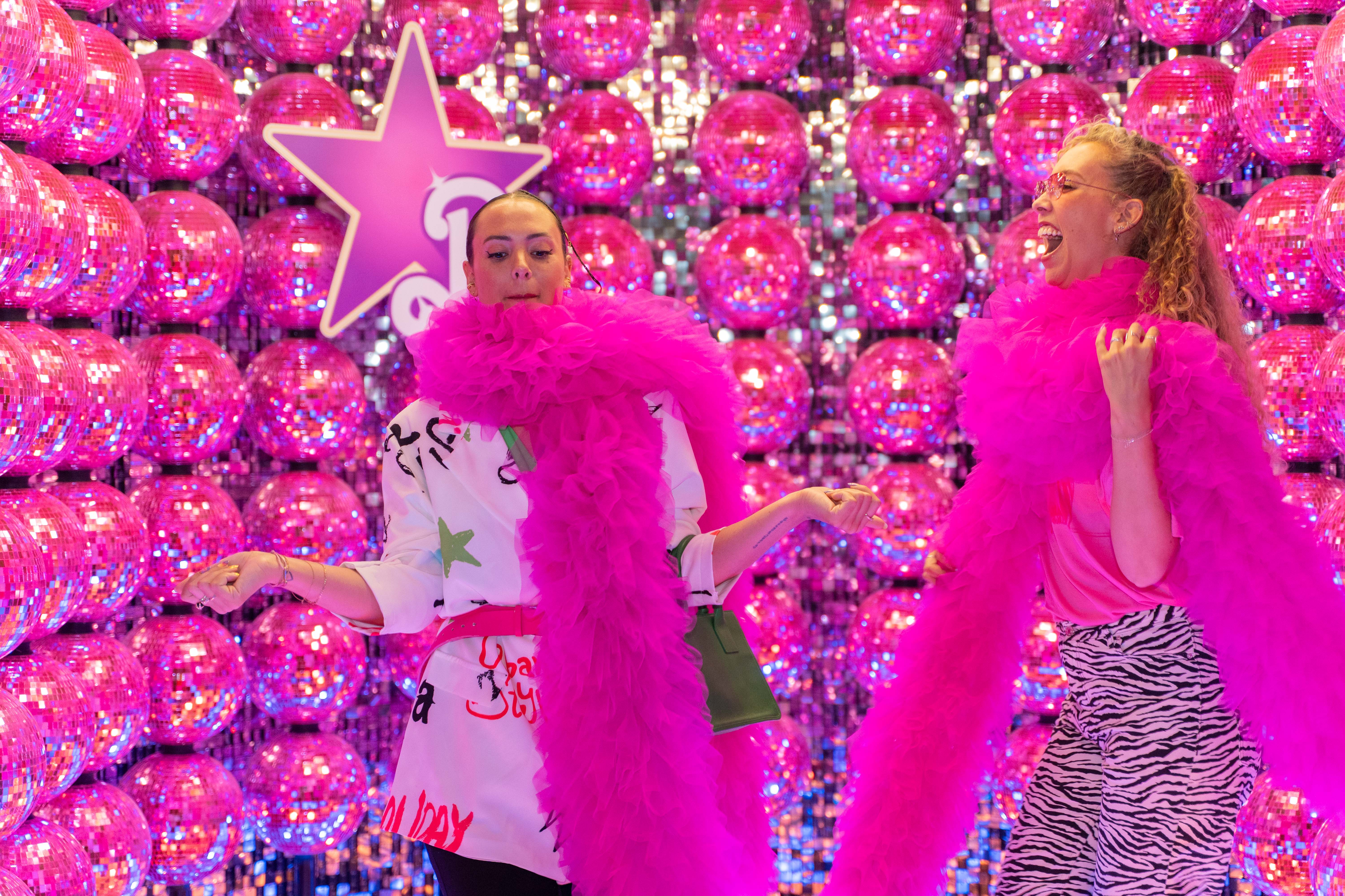 two-woman-dancing-wearing-pink-in-pink-discoball-room