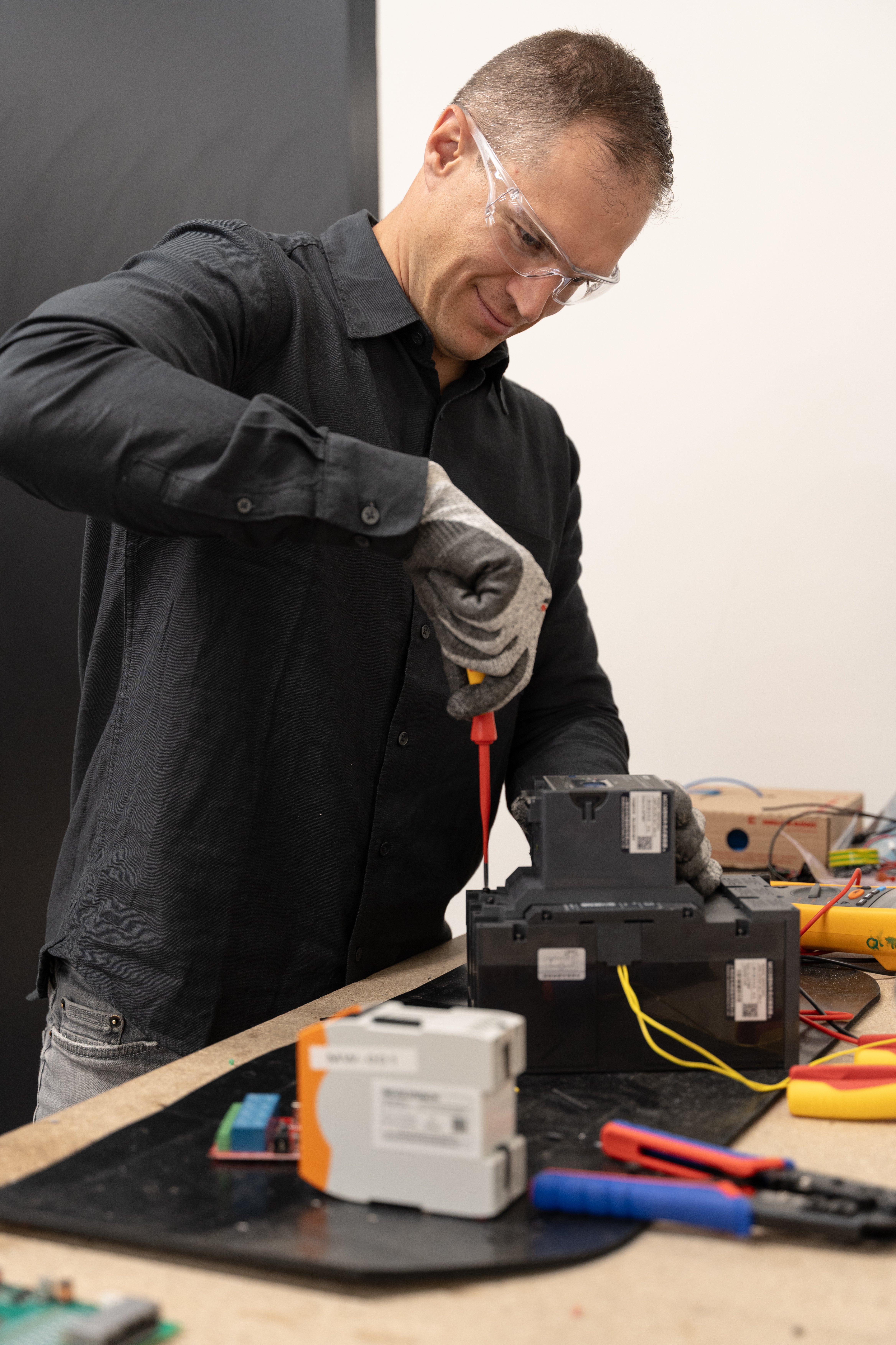 Man holding a screwdriver and working on a product.