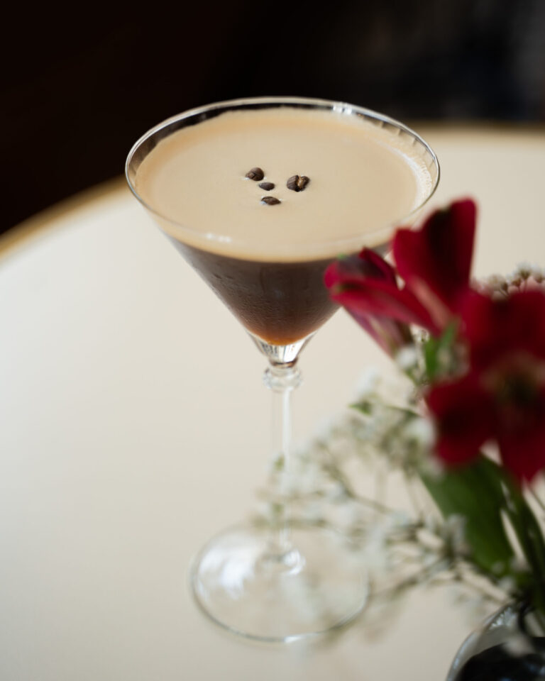 High-end cocktail espresso martini with flowers.