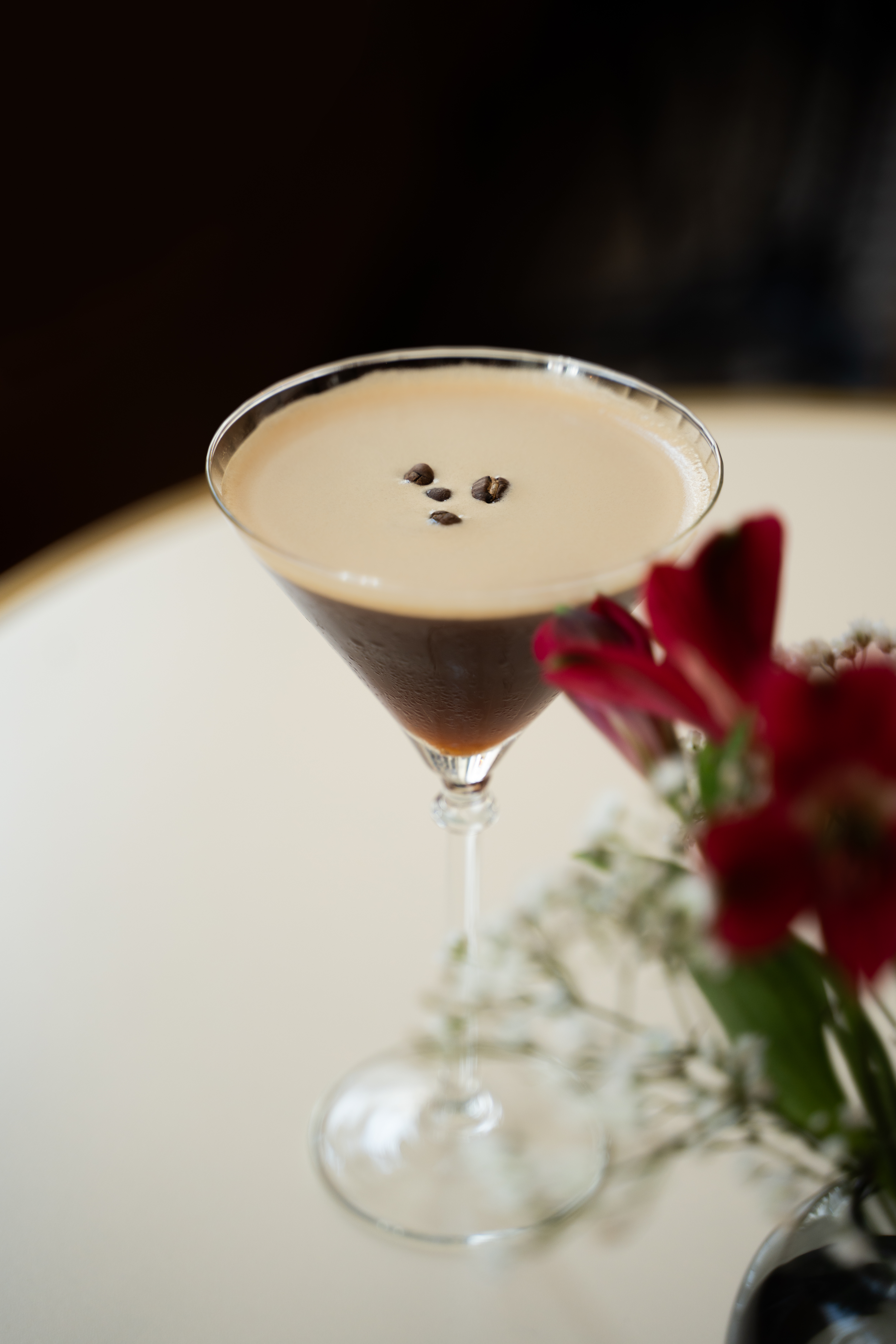 High-end cocktail espresso martini with flowers.
