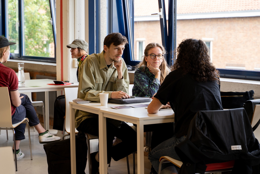 Three people sitting together at a table
