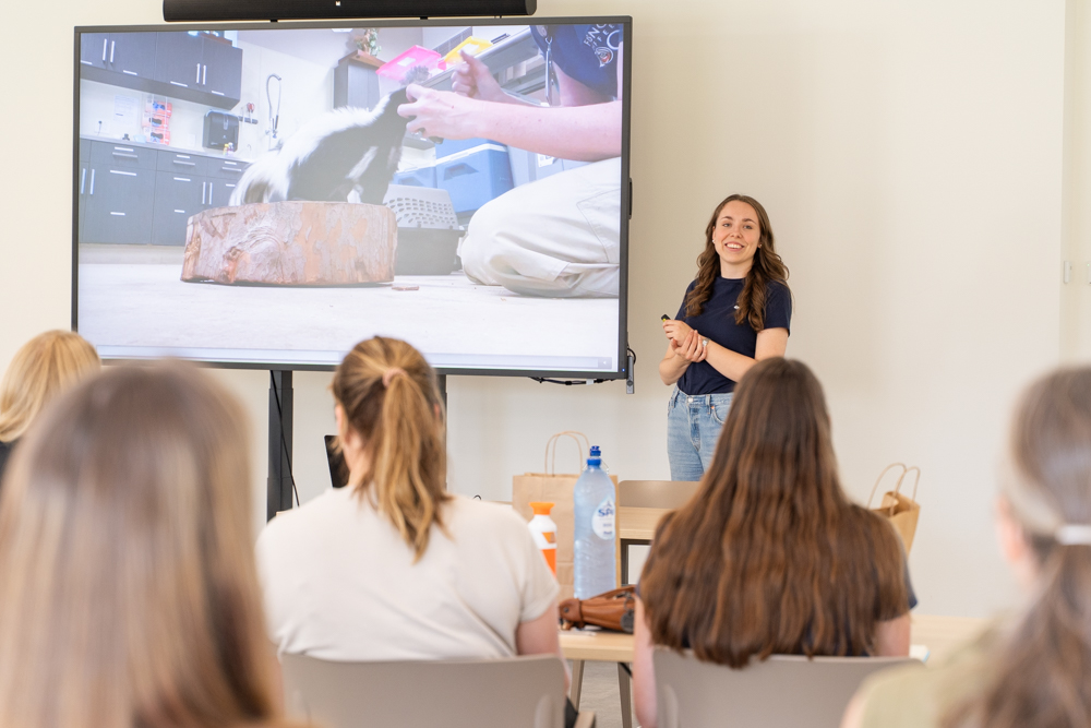 Woman giving a presentation next to a screen